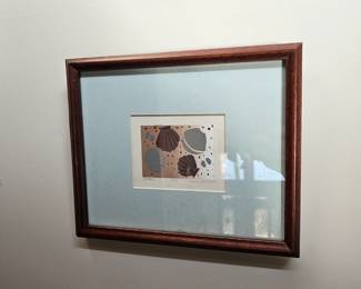 Framed artwork of seashells in shades of brown