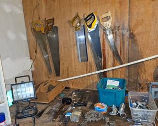 Assorted hand saws, work light, stapler, assorted tools