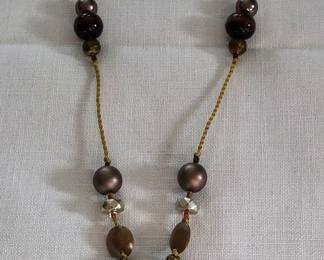 The basket is cloisonné with beautiful beads on a strand