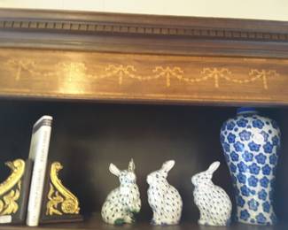 Decorative hand-painted detail at top of bookcase