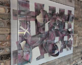 Abstract 3D paper installation housed within a Plexiglass box, featuring interwoven strips of paper with a textured painted/dyed surface in shades of purple, pink and grey.  Signed by artist