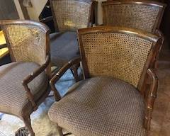 4 solid wood cane backed chairs. One chair has damage
