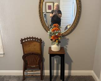 Folding Rocking Chair, Small Plant Stand, Oval Mirror, and flower arrangement