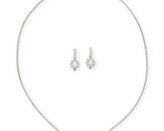 1054
A Group of 18K White Gold and Diamond Jewelry
Including a necklace and earrings of similar design featuring round diamonds weighing approximately 1.00 carat total
Necklace: 15 in., Earrings: 3/4 in.
7.1 grams gross
Estimate: $500 - $700