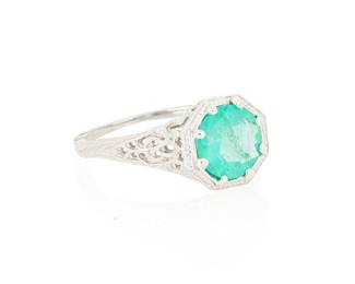 1033
An 18K White Gold and Emerald Ring
Centering a round emerald weighing approximately 1.30 carats, set in a filigree design
Size: 6
3.3 grams gross
Estimate: $400 - $600