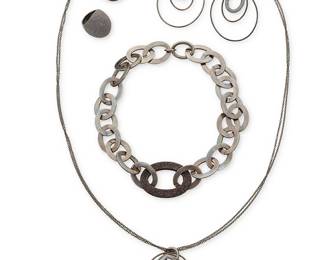 1061
Pesavento: A Group of 'Polvere Di Sogni' Sterling Silver Jewelry
Featuring a chunky chain link collar necklace of blackened sterling silver oval links with a central powdered brown 'polvere' glitter link, and two similar style domed brown polvere cocktail rings, as well as a delicate darkened brown sterling silver sautoir necklace suspending a graduated oval hoop pendant and a pair of matching earrings, each signed and with Italian assay marks
6 pieces
Necklaces: 34 in. L & 19 1/2 in. L; Earrings: 3 in. H; Ring sizes: 8
151.3 grams gross
Estimate: $600 - $800