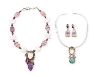 1078
Sajen: A Group of Sterling Silver and Gemstone Jewelry
Comprising a chunky bead necklace with freshwater pearls, amethysts, and fluorite beads suspending a sterling silver pendant with set charoite and a carved bone face, as well as a silver wire choker necklace suspending a sterling silver pendant /brooch with set turquoise, moonstone and a carved bone face, and a pair of sterling silver and amethyst crystal earrings, each variously marked for Sajen and for sterling
5 pieces
Necklace: 18 1/2 in. L x 2 1/2 in. H; choker: 14 in. L x 2 3/8 in.; earrings: 1 7/8 in. H
165.8 grams gross
Estimate: $300 - $500