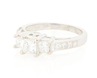 1169
An 14k White Gold and Diamond Ring
Centering a princess-cut diamond weighing approximately 0.45 carat, accented by graduated princess-cut diamonds weighing approximately 1.20 carats
Size: 7 1/2
4.21 grams gross
Estimate: $800 - $1,200