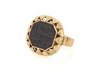 1135
A Gold and Hardstone Ring
Featuring an octagonal-cut black hardstone inscribed with Sanskrit, set in an ornate texturing design
Size: 7 1/2
13.5 grams gross
Estimate: $800 - $1,200