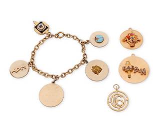 1136
A Gold and Mixed Metal Charm Bracelet and Charms
Featuring a 10k gold link bracelet suspending one 9k gold charm, three 12k gold charms, one 14k gold charm and three base metal charms
4 pieces
Measures: 7 1/2 in.
42.5 grams gross
Estimate: $400 - $600