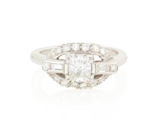 1051
A Platinum and Diamond Ring
Centering a princess-cut diamond weighing approximately 0.75 carat, accented by round and baguette diamonds
Size: 8 with hinged shank
6.7 grams gross
Estimate: $800 - $1,200