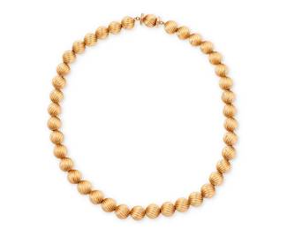 1003
Ruser: A 14K Gold Bead Necklace
Of a single strand design featuring twisted textured gold beads, signed Ruser, with original pouch
Length: 15 3/4 in.
20.0 grams gross
Estimate: $1,000 - $1,500