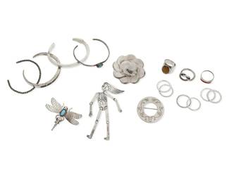 1087
A Group of Sterling Silver Jewelry
Comprising four narrow silver cuff bracelets in various styles including one by Ray Tracey (Navajo/Diné) & Knifewing Segura (Chiricahua Apache), together with four silver brooches including a sterling silver butterfly brooch with set turquoise by Fatoya Yazzie (Navajo/Diné), as well as nine silver rings, including a Mexican silver ring with tiger's eye cabochon, and a Vahan sterling silver knot ring, most marked for sterling and for maker
18 pieces
Cuffs: 5 3/4 in. to 6 1/4 in. inner C ; Brooches: 3 1/2 in. to 1 1/2 in. H; Ring sizes: 7 3/4 to 5 1/2
127.7 grams gross
Estimate: $700 - $900