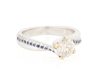 1035
An 18K White Gold and Diamond Ring
Centering a round diamond weighing approximately 0.90 carat, accented by round sapphires and diamonds
Size: 6 1/4
5.7 grams gross
Estimate: $700 - $1,000