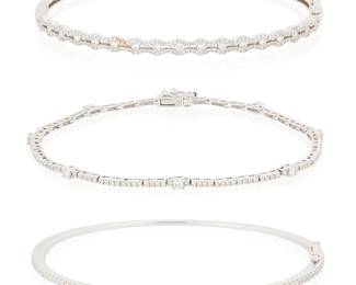 1030
A Group of Three 18K White Gold and Diamond Bracelets
Including two hinged oval bangles accented by round diamonds and a flexible bar link bracelet set with round diamonds
3 pieces
Lengths: 6 1/2 in., 6 3/4 in., 7 in.
21.2 grams gross
Estimate: $700 - $900