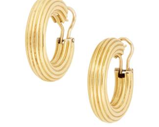 1005
A Pair of 18K Gold Hoop Earrings
Featuring a striped gold design, with Italian assay marks
Measures: 1 1/4 x 1/4 in.
13.7 grams gross
Estimate: $700 - $900