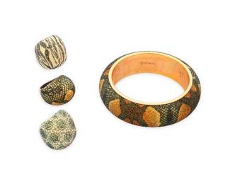 1071
Pesavento: A Group of 'Polvere Di Sogni' Sterling Silver Jewelry
Featuring a chunky domed bangle bracelet with multi-colored snakeskin pattern 'polvere' powdered glitter on rose gold-plated sterling silver, with a matching darkened sterling silver domed cocktail ring, as well as two further domed dark sterling silver rings with green and opalescent polvere glitter, one with zebra pattern and one in floral lace pattern, each signed and with Italian assay marks
4 pieces
Bangle: 8 in. inner C.; Ring sizes: 8 & 7 1/2
135.5 grams gross
Estimate: $500 - $700