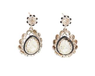 1156
A Pair of 18K White Gold and Diamond Earrings
Featuring two antique pear-shaped diamonds weighing approximately 0.85 carat each, encircled by black enamel
2 pieces
Measures:7/8 x 1/2 in.
5.3 grams gross
Estimate: $1,000 - $2,000