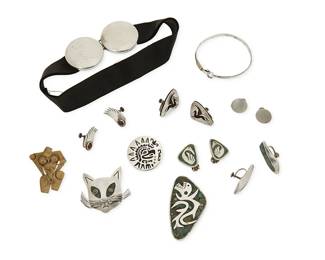 1066
A Group of Silver and Mixed Metal Jewelry
Mid/late 20th century
Most variously marked for maker, for Mexico and for sterling; further variously marked: [Eagle 3]
Ten works in sterling silver and mixed metal, some with set stones and stone inlay, by various makers including Enrique Ledesma, Bernice Goodspeed, and Thomas Mann, comprising four figural brooches in various designs including a cat face and a serpent, as well as five pairs of earrings including a pair with shadowbox Pegasus motif, and one pair with bird motifs, together with a black ribbon choker necklace with round sterling "belt buckle" clasp, and a sterling silver wire bangle with 10K gold accent and decorative spring latch,
16 pieces

Choker: 14 1/2 in x 1 1/2 in.; Bangle: 6 3/4 in. inner C; Largest brooch: 1 3/8 in. H x 2 1/2 in. W; Largest earring: 1 3/8 in. H
116.2 grams gross
Estimate: $100 - $200