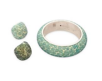 1072
Pesavento: A Group of 'Polvere Di Sogni' Sterling Silver Jewelry
Featuring three items designed with green and opalescent 'polvere' powdered glitter on sterling silver, including a chunky domed bangle bracelet and matching ring in a green and white spiral pattern, as well as a dark sterling silver domed ring in a floral lace pattern, each signed and with Italian assay marks
3 pieces
Bangle: 8 in. inner C.; Ring sizes: 7 1/2
117.2 grams gross
Estimate: $500 - $700