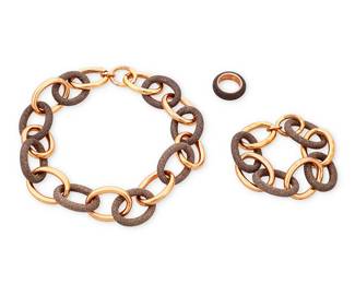 1069
Pesavento: A Group of 'Polvere Di Sogni' Sterling Silver Jewelry
Featuring a chunky chain link necklace with alternating rose gold-plated sterling silver links and powdered brown 'polvere' glitter links, with a matching bracelet, and a similar style band ring, each signed and with Italian assay marks
3 pieces
Necklace: 18 1/2 in.; bracelet: 9 1/2 in.; Ring size: 7 1/2
146.8 grams gross
Estimate: $700 - $900