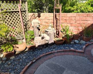 Outdoor arch, statues, potted plants