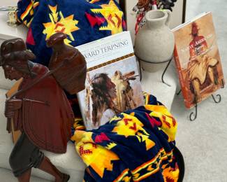 Indian blanket, pots on stands and books