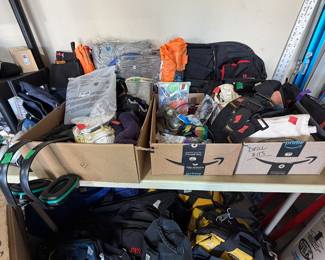 Lots of tool bags, tool belts, safety equipment - protective eye wear, gloves, masks