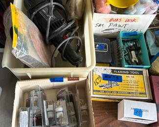 bottom left: Delta faucet replacement parts upper right: Craftsman sander/polisher with supplies lower bottom small box: flaring tool