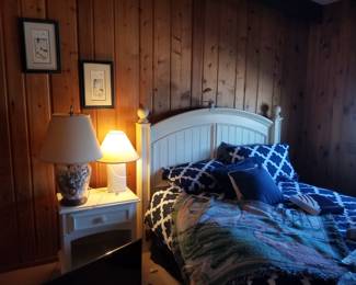 Cottage chic queen bed; matching nightstand. Table lamps