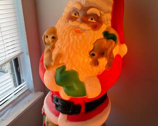 Vintage blow mold illuminated Santa with puppies