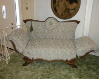 Very unique walnut fainting couch.  Fabulous shape. No pets, no smokers. Arms fold up or down.