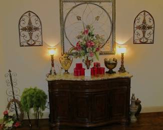 Stunning console with a stone top and accented with gorgeous decor.