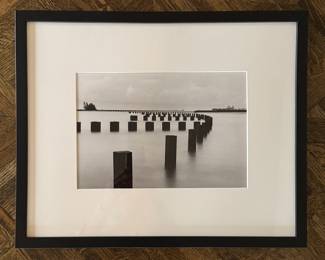 Framed Black & White Photograph of Pilings. Measures  21.25" x 17.25" Overall.