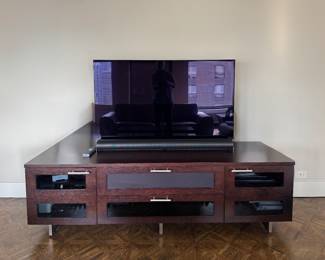 BDI Avion Media Console in Expresso Stained Oak. Measures 77" W x 42" D x 22.5" H. Pictured with LG OLED TV & Sonos Sound Bar. Photo 1 of 2.
