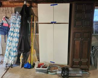 Umbrellas, Electrolux vacuum,  and storage cabinets