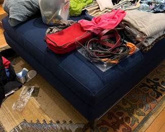 Upholstered ottoman; rug; women’s accessories