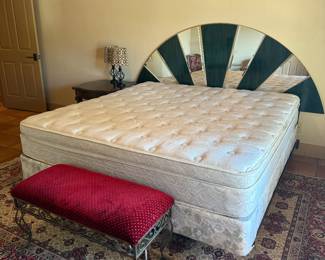 King size mattress, headboard, red velvet bench beautiful are rug.
