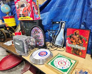 Prison TV, Neon Sign, Lighted Captain Morgan Sign, Bulova Cardinals Clock, Cubs Neon Clock, and Crown Royal Sign.