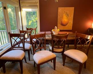 Lovely dining room table with 6 chairs and woodgrain protective table cover too!