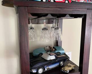 Antique crystal wine glasses; Several Corvette replica antique cars; Cherished Teddy figurines; Wine cabinet