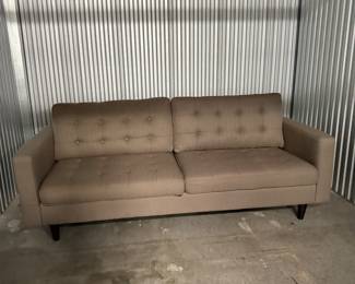 Tan tufted sofa