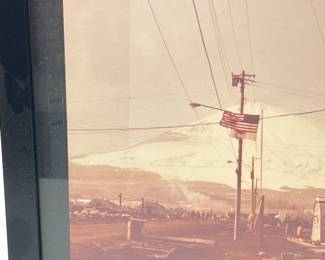 Striking Vintage US Military Outpost Photograph, c. WWII-1950s, Featuring Quonset Huts and American Flag Against a Majestic Snowy Mountain