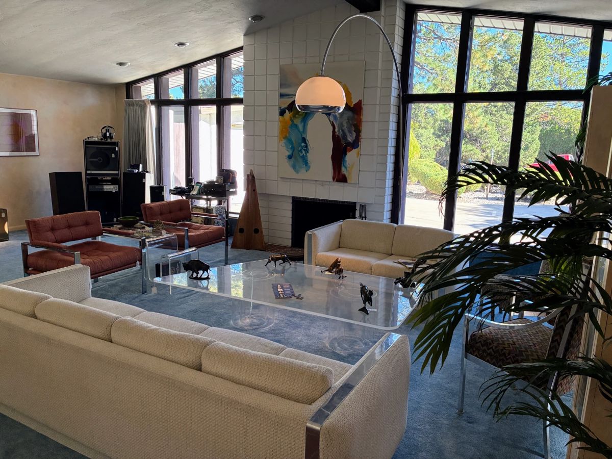 Harvey Guzzini style hand blown glass mushroom floor lamp; MCM lucite asymmetrical coffee table; MCM lucite magazine holder; Milo Baughman style sofa; Milo Baughman style loveseat; Milo Baughman style chrome upholstered chairs - pair