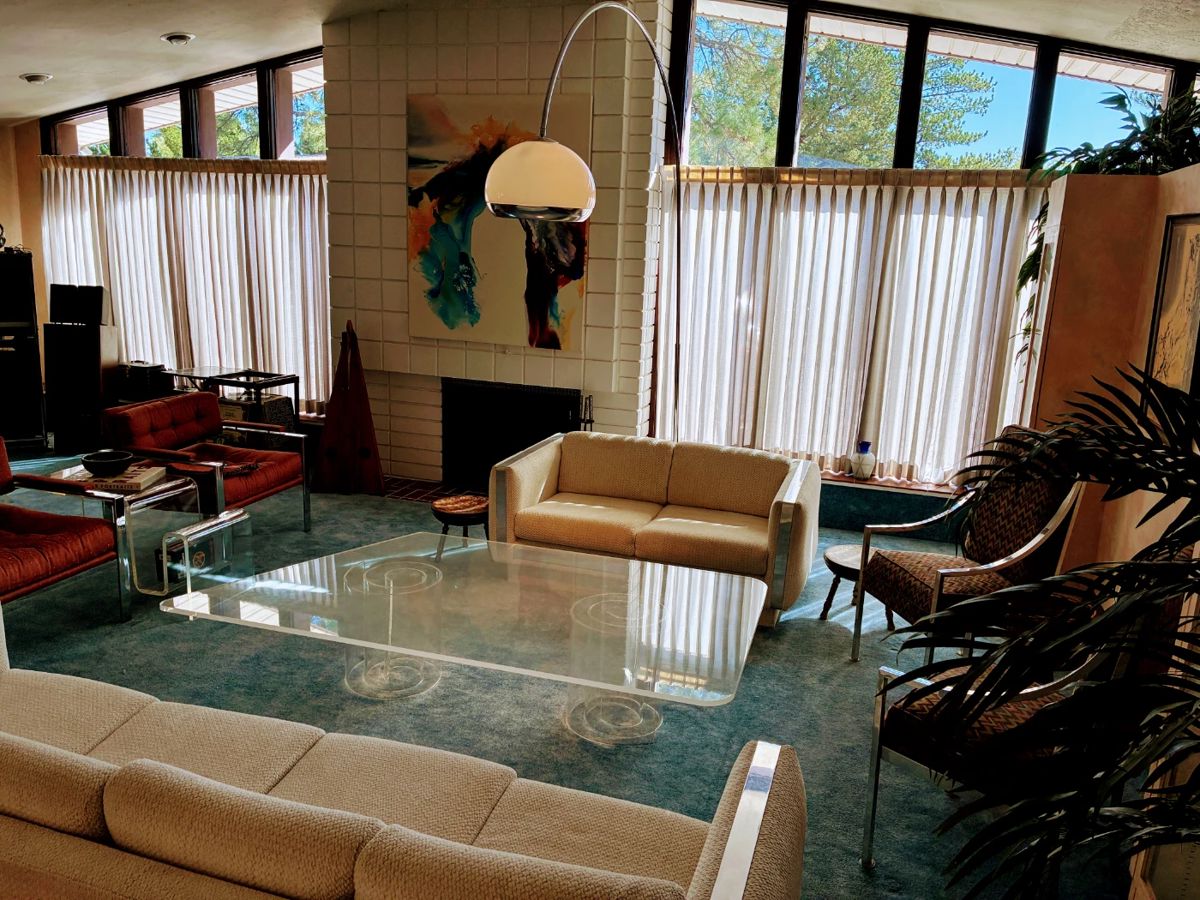 Harvey Guzzini style hand blown glass mushroom floor lamp; MCM lucite asymmetrical coffee table; MCM lucite magazine holder; Milo Baughman style sofa; Milo Baughman style loveseat; Milo Baughman style chrome upholstered chairs - pair