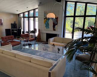 Harvey Guzzini style hand blown glass mushroom floor lamp; MCM lucite asymmetrical coffee table; MCM lucite magazine holder; Milo Baughman style sofa; Milo Baughman style loveseat; Milo Baughman style chrome upholstered chairs - pair