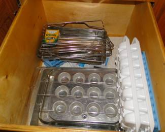 Mini muffin tins, ice cube trays, and cooling racks. No clue as to why a box of chalk is in there