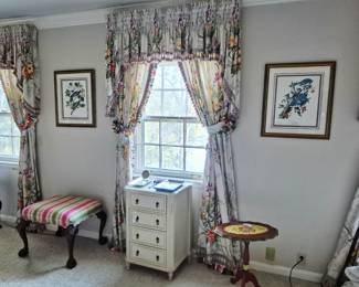 Custom lined floral curtains with tassels, vintage furniture and framed prints