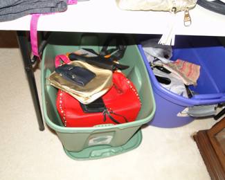 Buckets and tabletops filled with handbags and purses