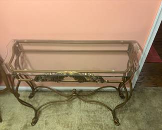 Beveled glasstop iron entry table with scroll detail.